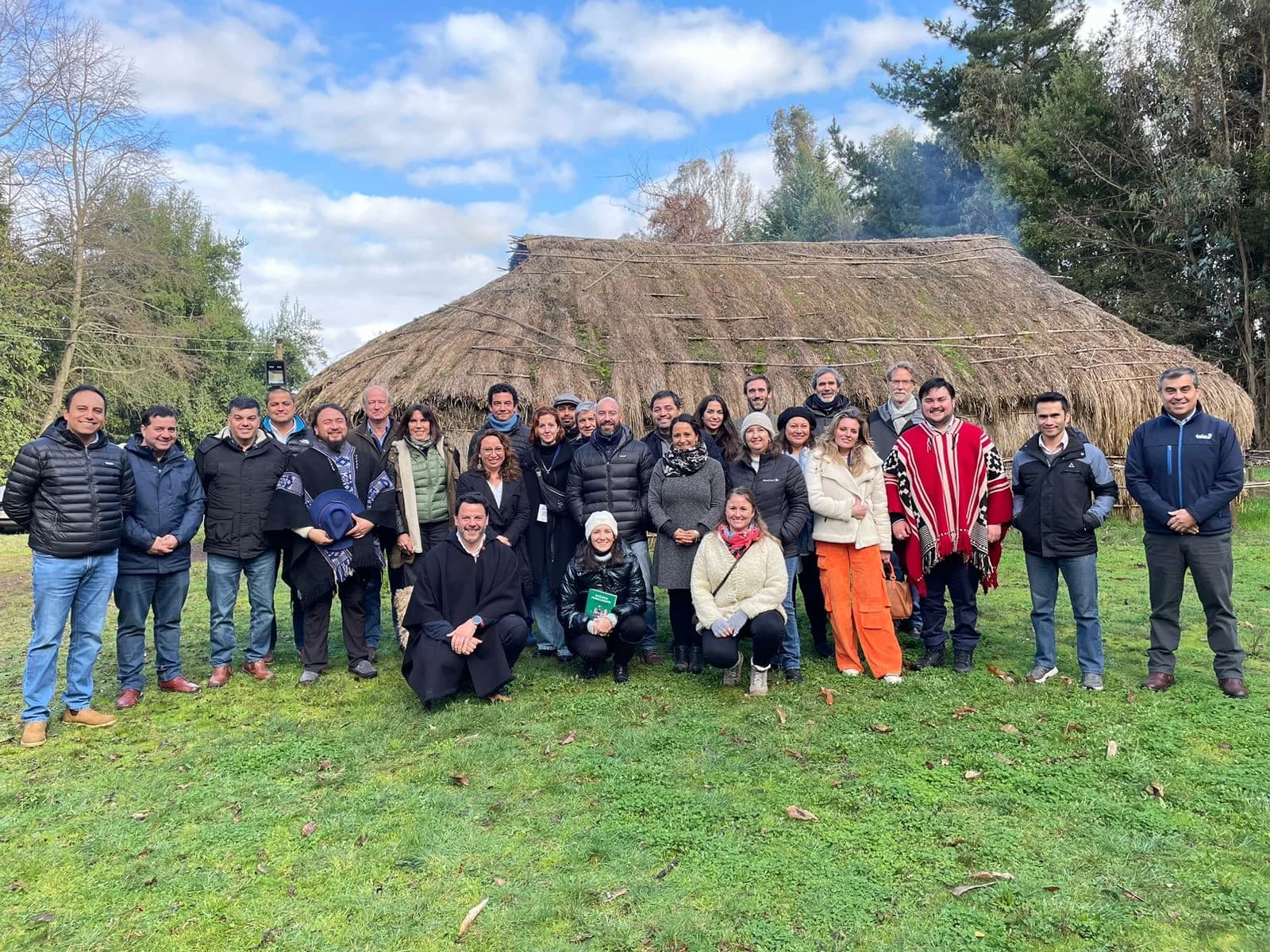 AMCHAM delegation and communities gathered in front of a ruka in Mapuche territory
